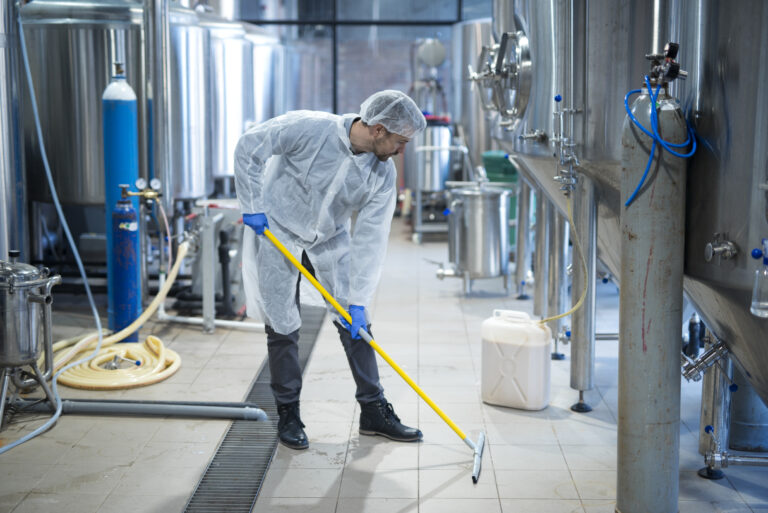 Specialist performing commercial mould removal in protective equipment