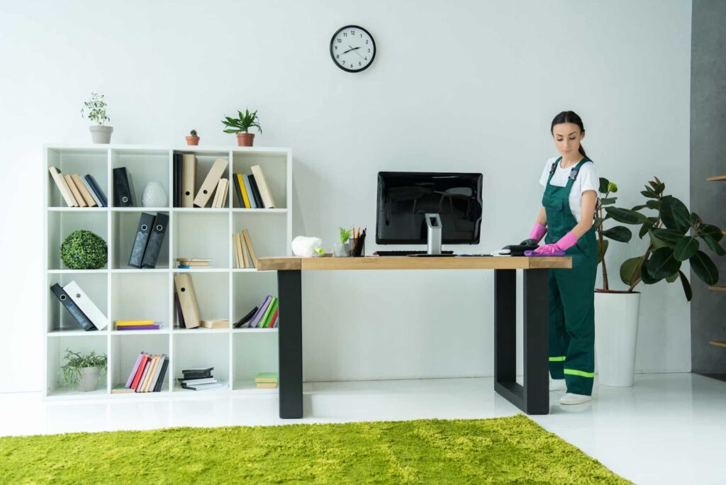 Professional cleaner in a modern office representing outsourcing office cleaning