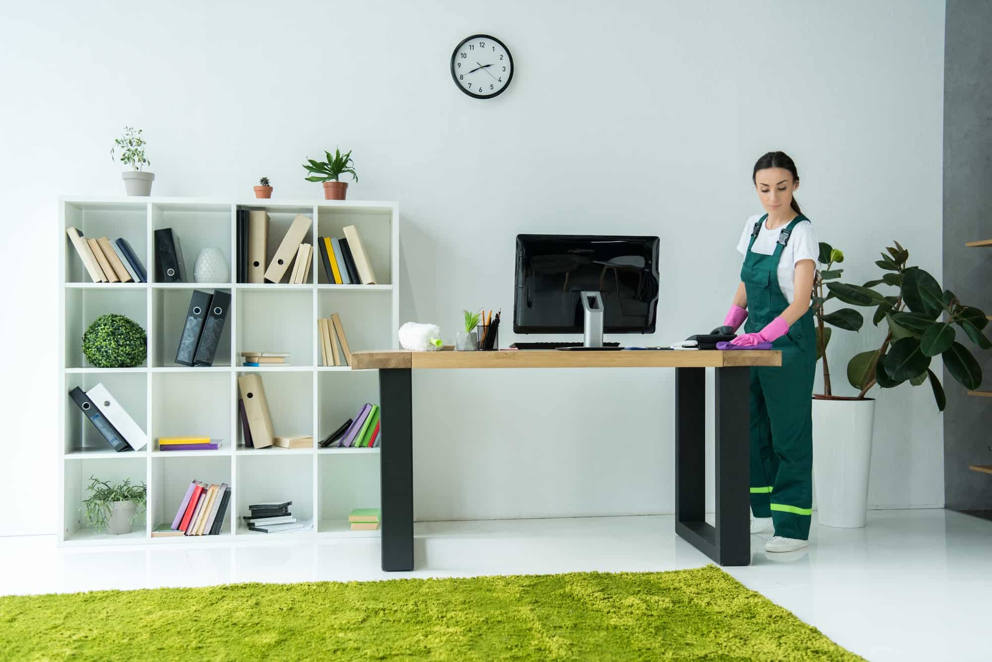 Professional cleaner in a modern office representing outsourcing office cleaning